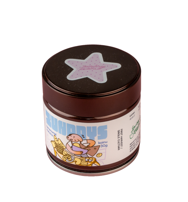Koinu Matcha tin by xundays with a lilac star lid and illustrated label